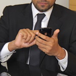 Young business man using a smartphone in an office setting