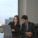 Two Professionals Looking at a Laptop