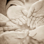 Sepia toned hands in a circle