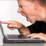 Angry man yelling at laptop